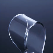 Clear, curved glass object on a dark blue background