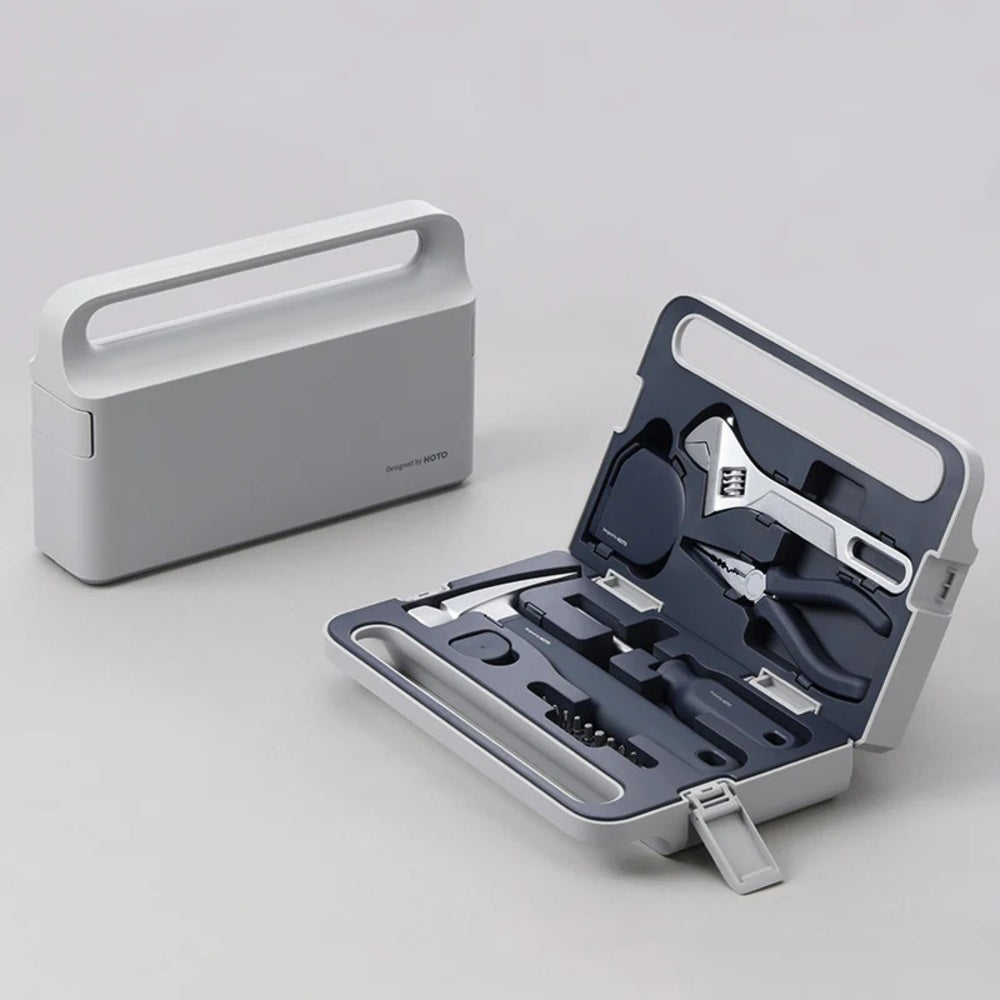 Tool kit with open case displaying various tools on a light gray background