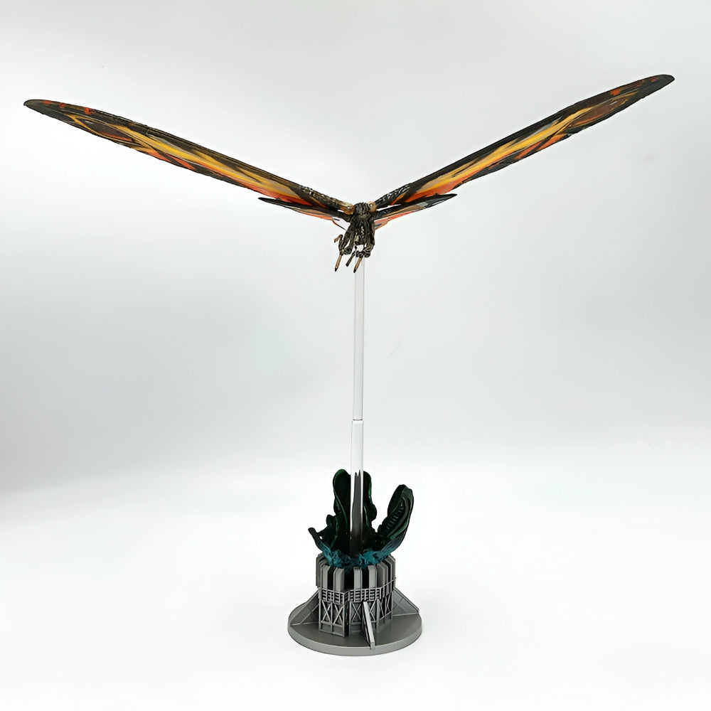 Model of a dragon with outstretched wings on a stand against a white background