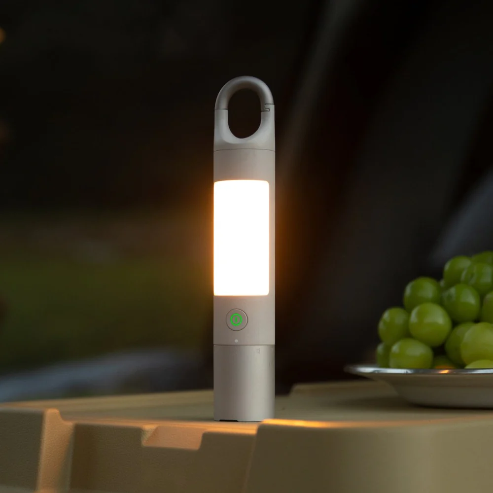 HOTO Flashlight Duo 1000 Lumens Dual-Light Rechargeable Torch Portable light on a table with grapes in the background