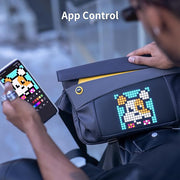 Divoom Pixoo Slingbag‑V Smart LED Sling Bag (4.7" Pixel Screen, App Control) Person using a smartphone app to control a pixelated design on a bag.