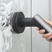 HOTO Cordless Spin Scrubber 6 Brush Head Set Handheld shower head with water spraying against a light grey wall