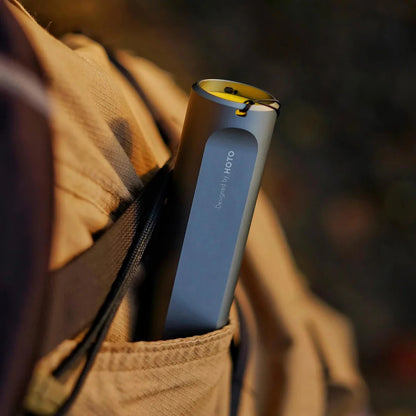 Blue and yellow device with 'Aloft' branding in a pocket of a brown jacket.