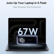 Laptop with a power adapter displaying '67W' on a light blue background.