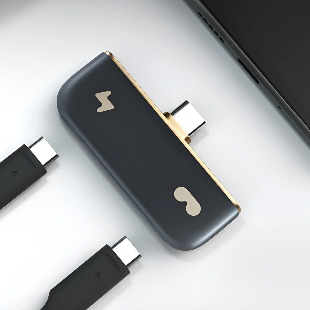 Rokid Hub USB‑C Adapter (Pass‑Through Charging, Switch Dock Mode, Dual USB‑C Out) Black and gold electronic device with multiple connectors on a light gray background