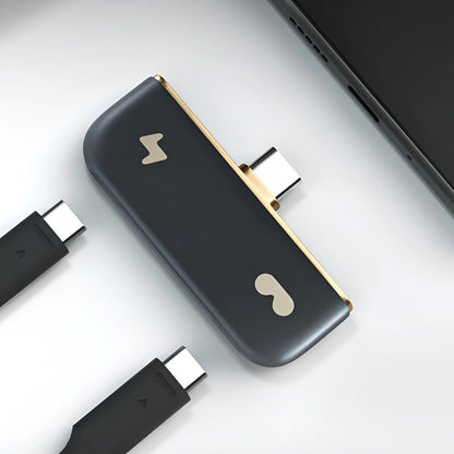 Rokid Hub USB‑C Adapter (Pass‑Through Charging, Switch Dock Mode, Dual USB‑C Out) Black and gold electronic device with multiple connectors on a light gray background