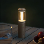 hoto-portable-camplight-rechargeable-camping-light-ipx6 Portable lamp on a wooden surface with a dark background
