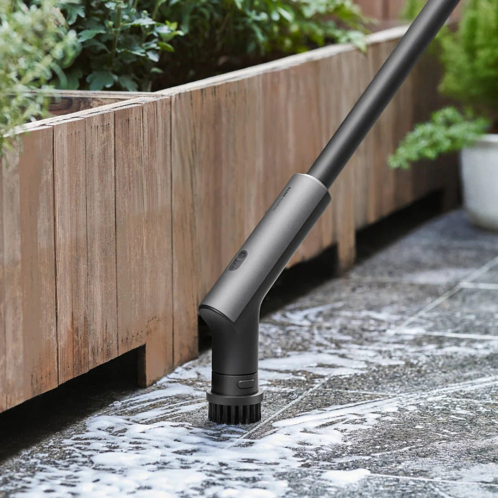 HOTO Cordless Spin Scrubber 6 Brush Head Set Gardening tool on a stone surface with plants in the background
