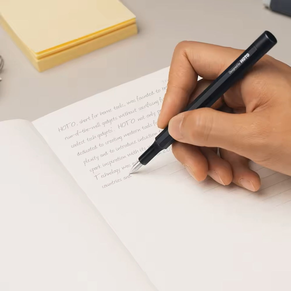 HOTO Pocket Precision Screwdriver SE Hand writing in a notebook with a pen on a light surface