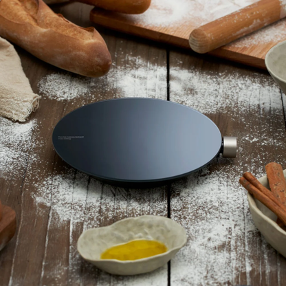 HOTO Smart Kitchen Scale, Black round object on a wooden surface with bread, rolling pin, and flour.