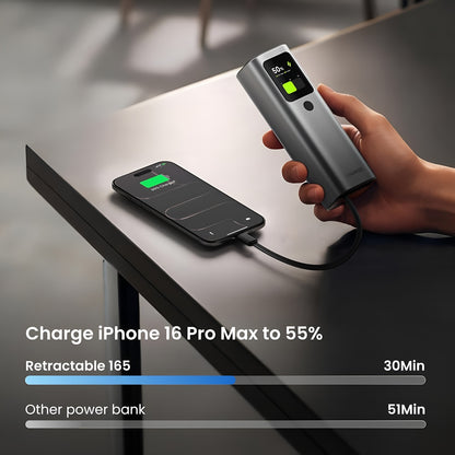 Sharge Retractable 165W Power Bank (20000mAh, Built‑in 100W USB‑C Cable) Hand holding a power bank charging an iPhone 16 Pro Max on a table.