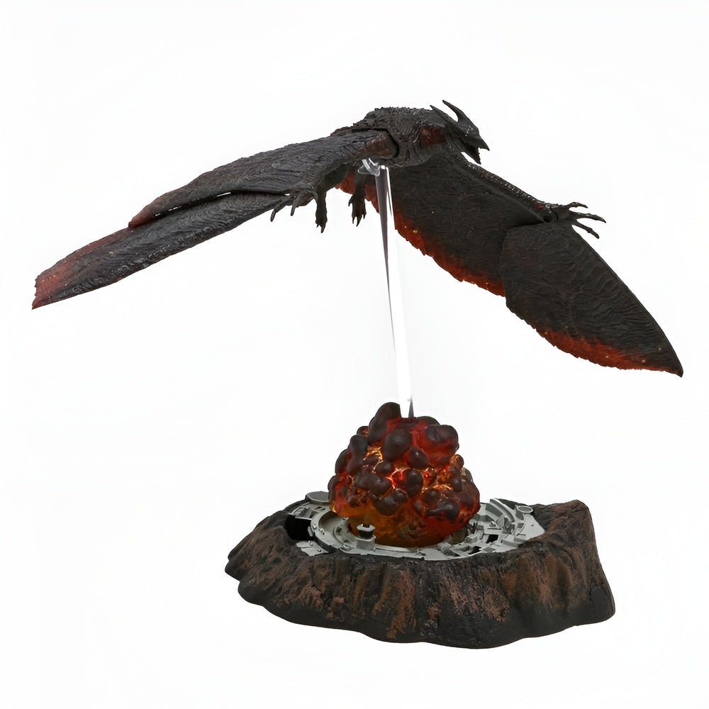 Decorative figurine of a dragon with wings spread, perched on a rocky outcrop with a glowing red sphere.