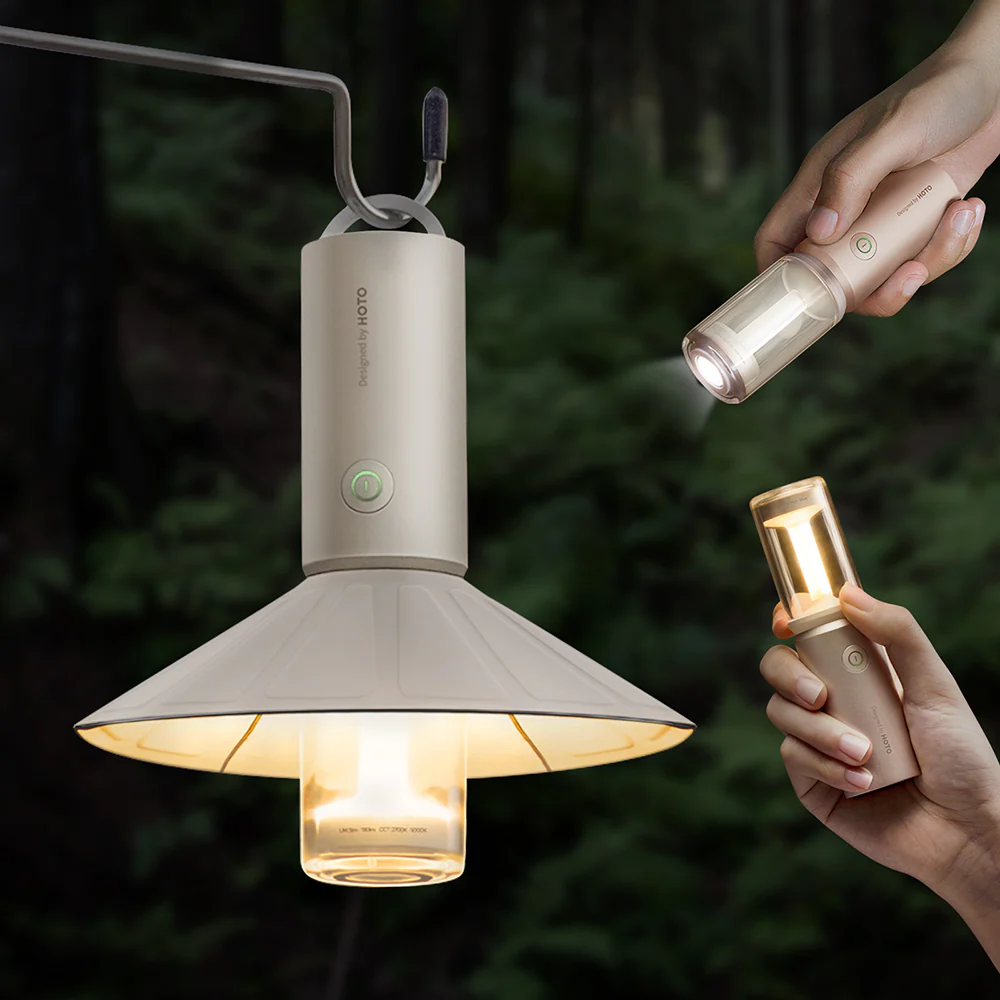 hoto-portable-camplight-rechargeable-camping-light-ipx6 Two hands holding a hanging lamp and a flashlight against a dark background