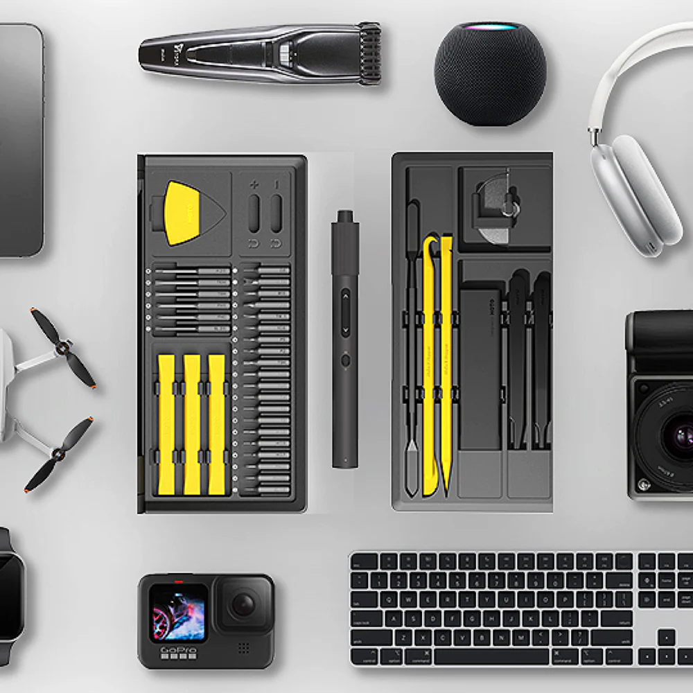 Collection of tools and electronic devices on a light gray surface