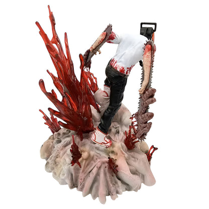 Gory figurine with red coral-like structure and a person in white shirt and black pants on a white background