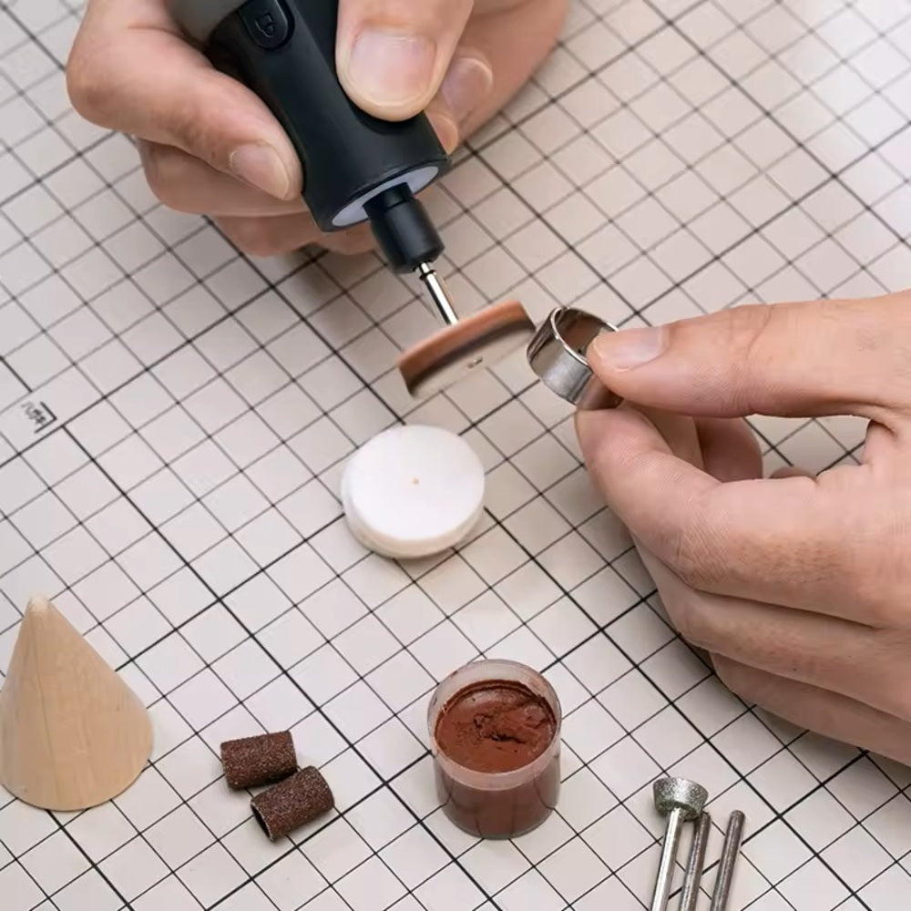 HOTO Rotary Tool Accessories Kit, Person using a small tool on a grid surface with various items including a wooden cone and brown substance.