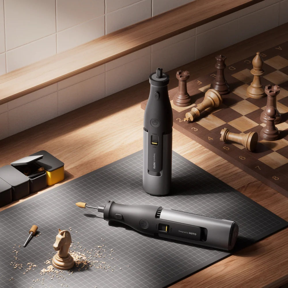 Two electric drills on a chessboard with chess pieces, one of which is being used to chip away at a chess piece.