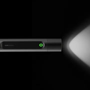 HOTO Flashlight Fit 280 Lumens Rechargeable Torch Black flashlight with a green light on, emitting light in a dark setting.