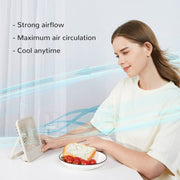 Jisulife Life1 Foldable Table Fan 2000mAh Portable USB-C Woman sitting at a table with a plate of food, using a small fan to cool herself.