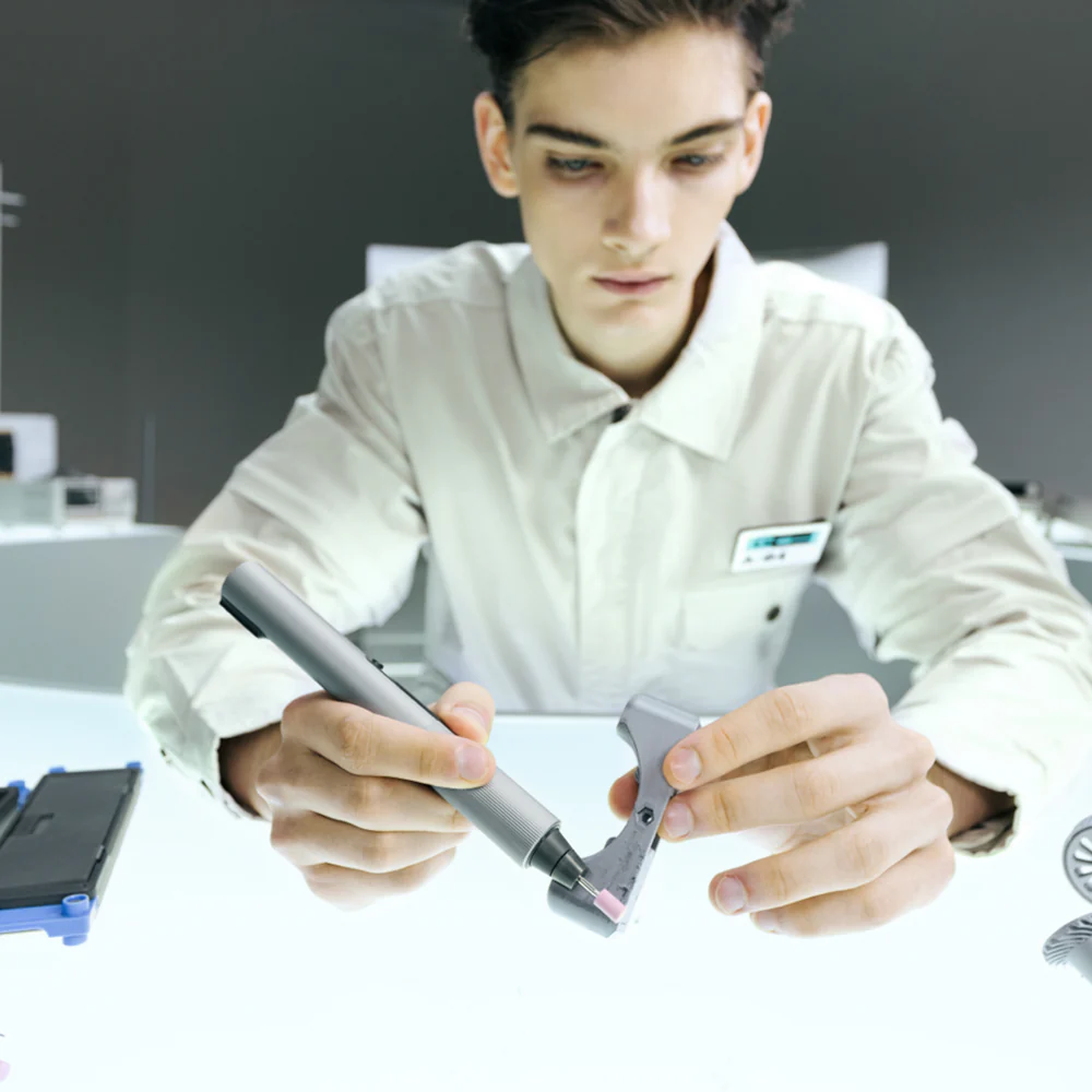 Person holding a pen and tablet in an office setting