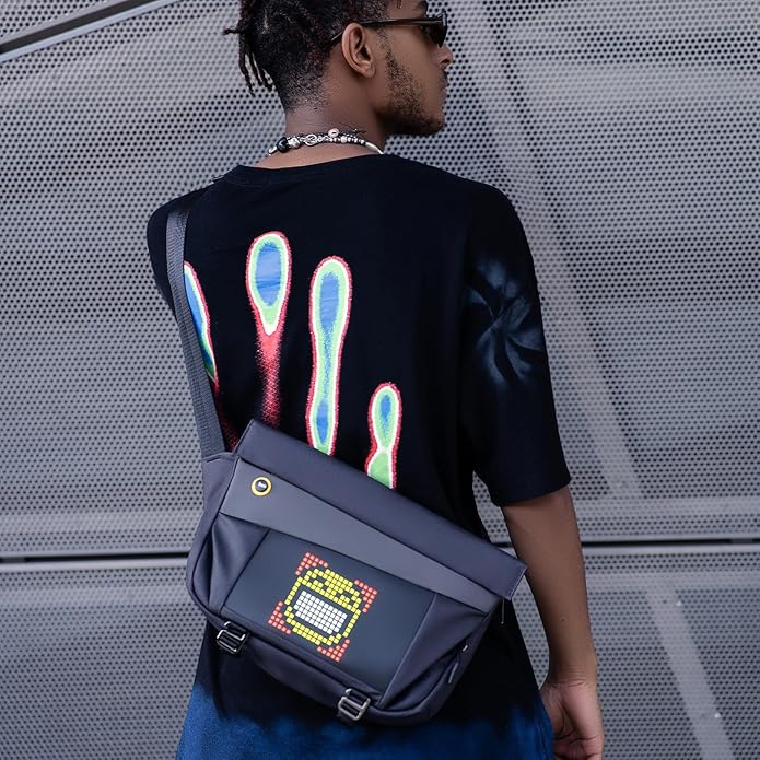 Divoom Pixoo Slingbag‑V Smart LED Sling Bag (4.7" Pixel Screen, App Control) Person wearing a black t-shirt with colorful designs and carrying a dark blue bag with digital display.
