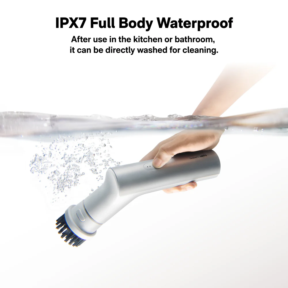 HOTO Electric Kitchen Scrubber 9 Brush Head Set Electric toothbrush being rinsed under water with text about IPX7 full body waterproof feature.