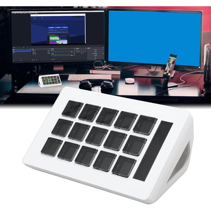 White numeric keypad with black keys in front of a computer setup with dual monitors.