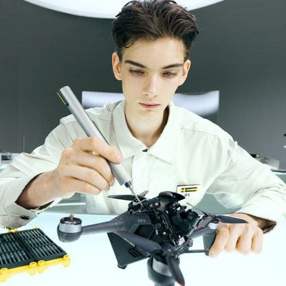 Person working on a drone in a workshop setting