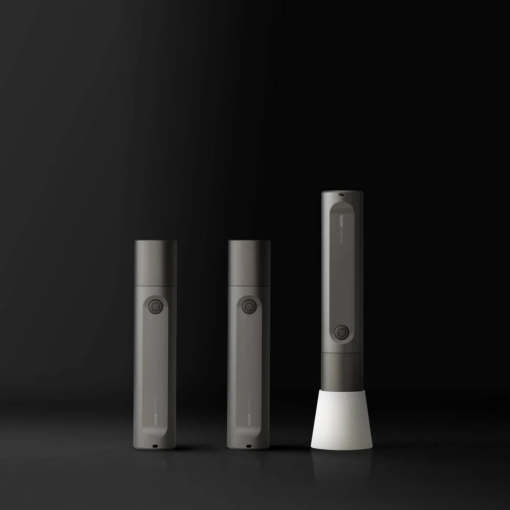 HOTO Flashlight Fit, Three gray electronic devices on a black background