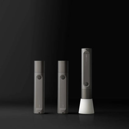 HOTO Flashlight Fit, Three gray electronic devices on a black background