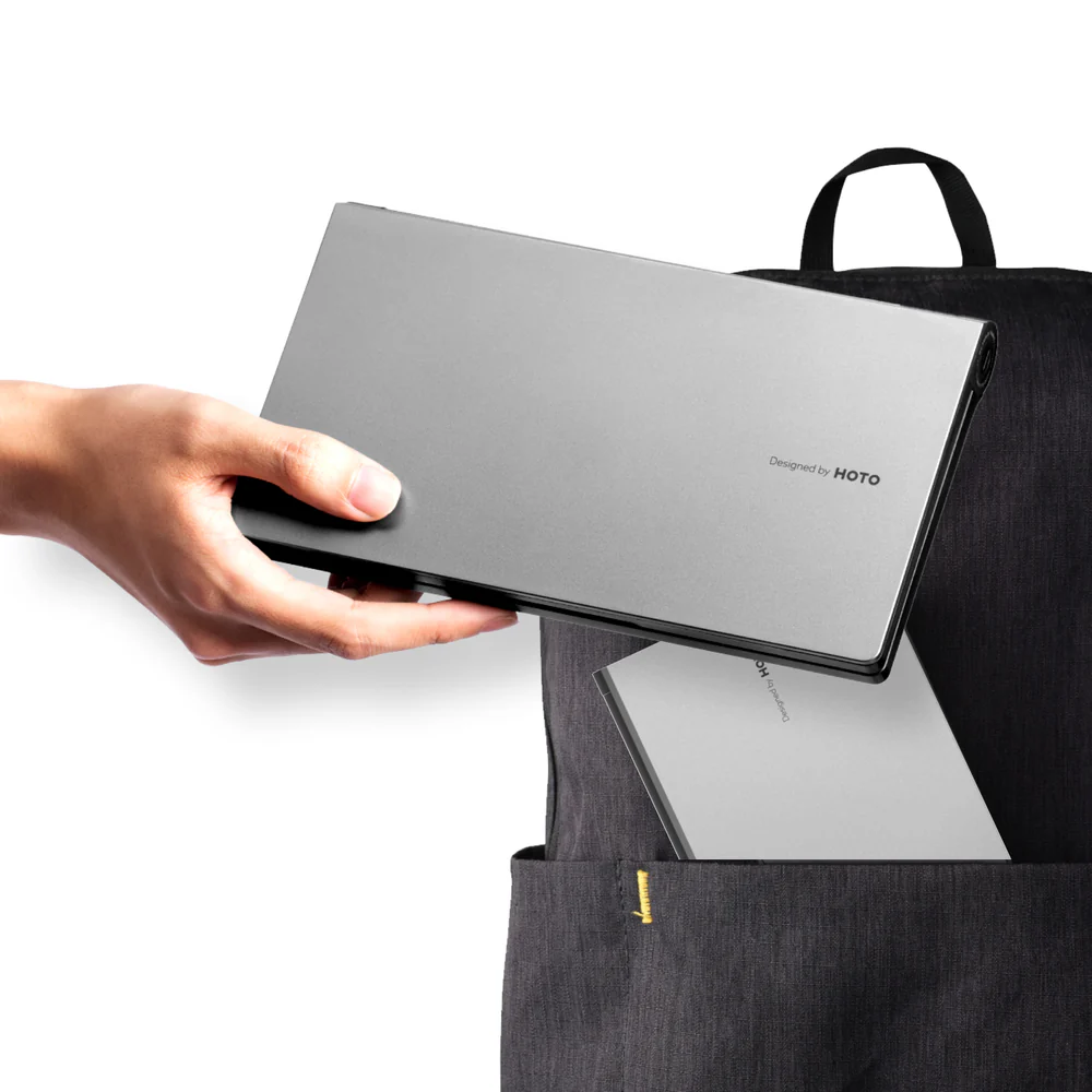 Person holding a gray laptop case with a black backpack on a white background