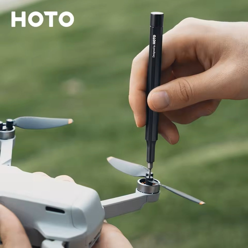 HOTO Pocket Precision Screwdriver SE Person using a small tool to adjust a drone's propeller with 'HOTO' branding.