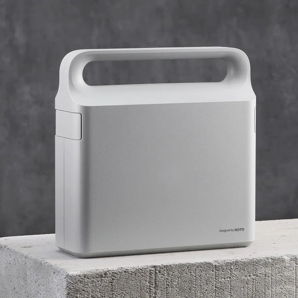 HOTO 12V Brushless Drill Tool Set, Gray portable device on a concrete surface with a dark gray background