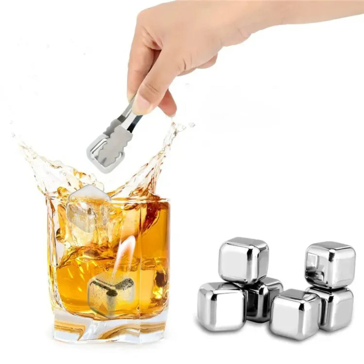 Stainless steel ice cubes being added to a glass of whiskey with a hand holding a tongs.