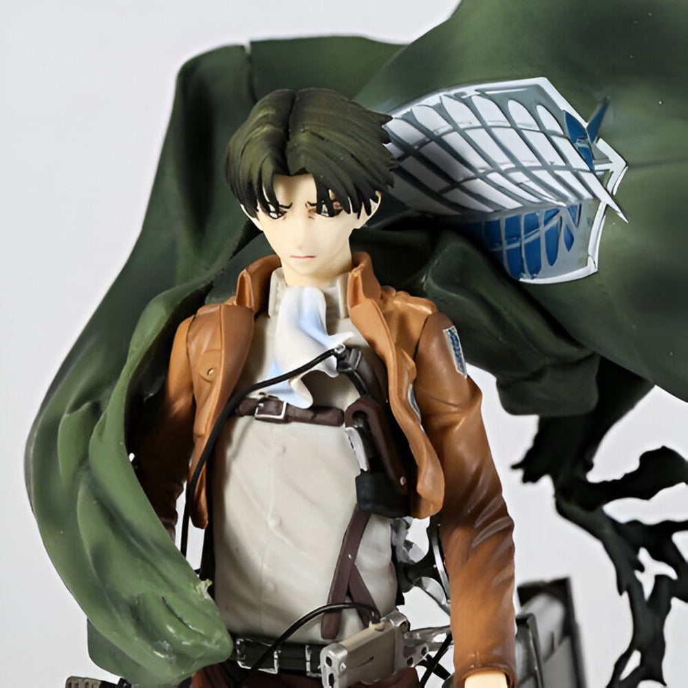 Figurine of a character from an anime or manga with a green cape and brown jacket.