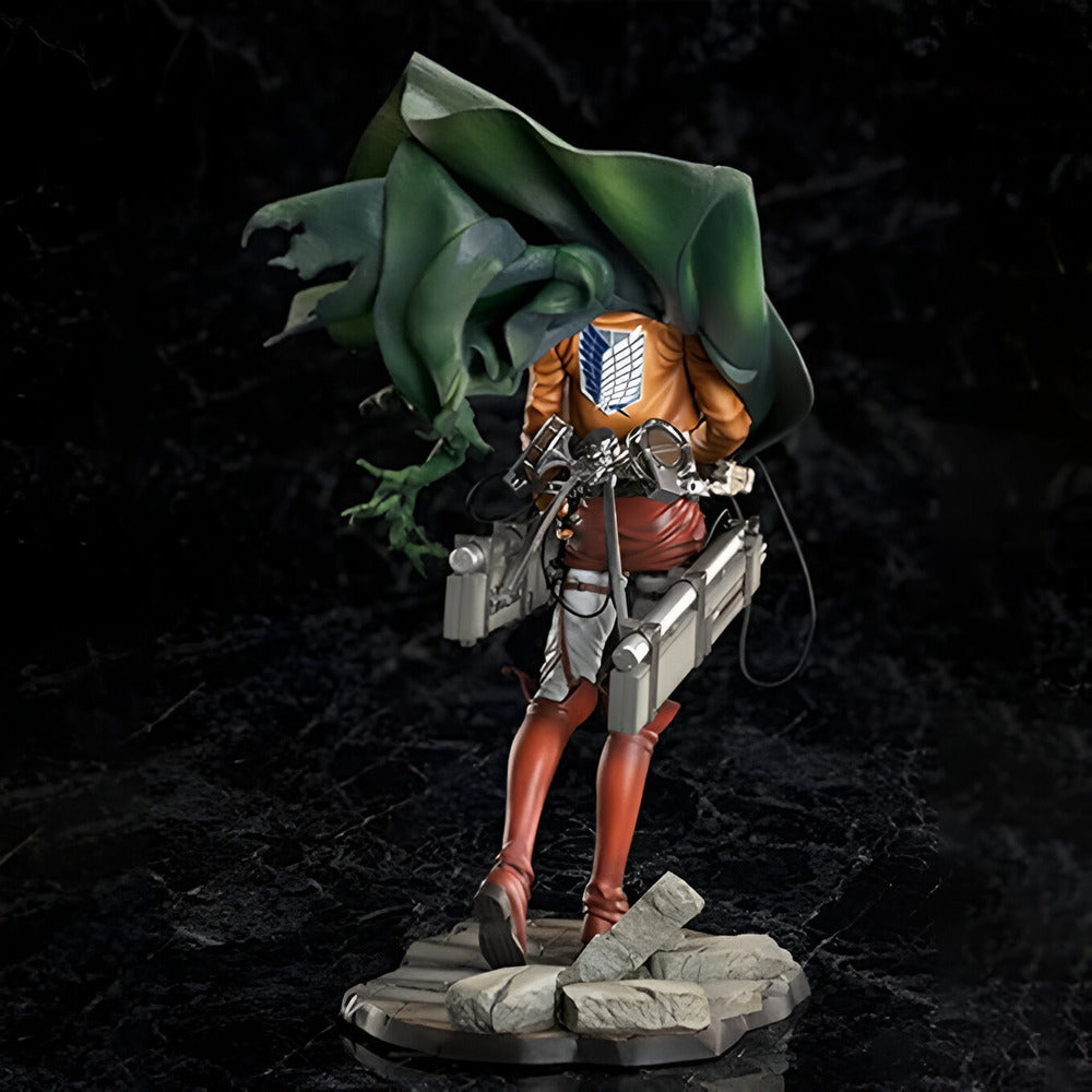 Figurine of a character with a green hood and armor on a dark background