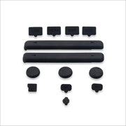 A collection of black rubber covers for Nintendo Switch ports and a glass screen protector.