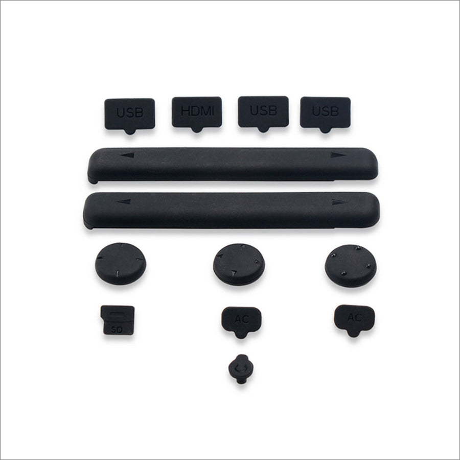 A collection of black rubber covers for Nintendo Switch ports and a glass screen protector.
