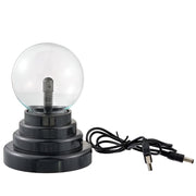 A compact decorative plasma globe light ball with a clear glass top and a black base, accompanied by a power cord.