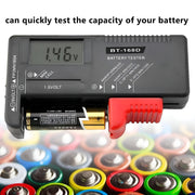 Battery tester with digital display on a background of various batteries Digital Battery Tester Volt Checker for 9V 1.5V & AA AAA Cell