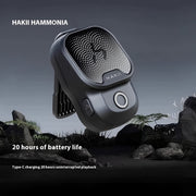 HAKII Boulder Clip-On Wearable Bluetooth Speaker, HAKII HAMMONIA speaker with battery life text on a dark background