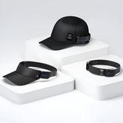 HAKII OG Wearable Open-listening Headphones Set, Black cap, visor, and bracelet on white geometric platform