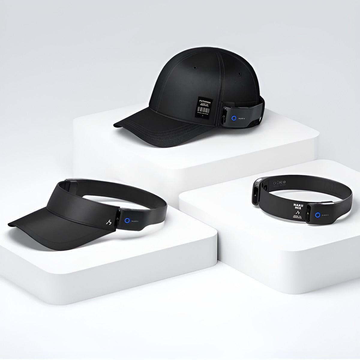 HAKII OG Wearable Open-listening Headphones Set, Black cap, visor, and bracelet on white geometric platform