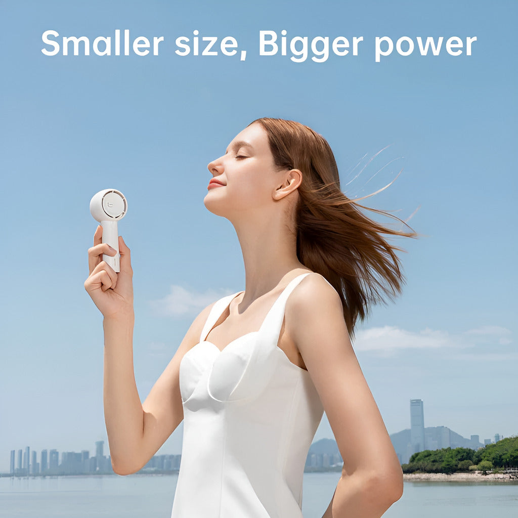 Jisulife Life5 Handheld Fan 2000mAh Portable Quiet USB-C Woman holding a white handheld device with a scenic background and text 'Smaller size, Bigger power'.