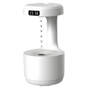 A white LED anti-gravity humidifier clock with a digital LED display screen showing time, featuring a unique design with water droplets seeming to flow upwards.