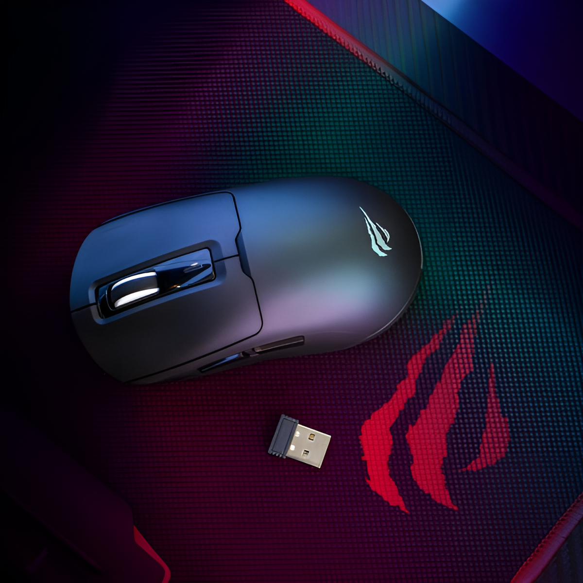 Gaming mouse with USB receiver on a dark surface with a logo.