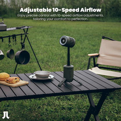 Portable air conditioner on a table outdoors with camping gear in the background