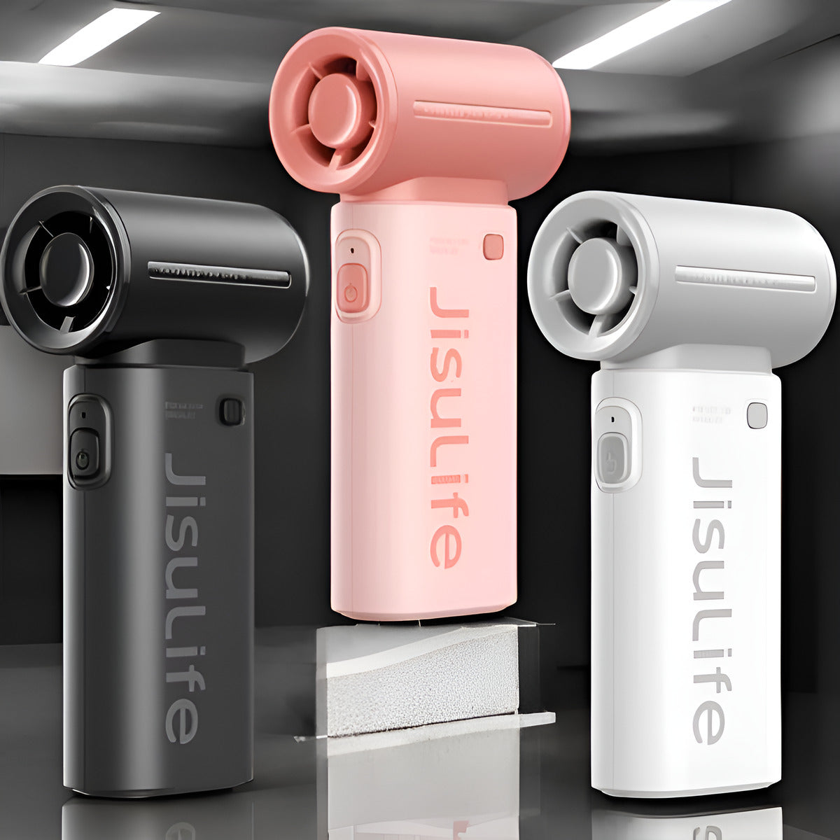 Jisulife Life9 Handheld Fan 3600mAh High Speed Portable Three Jisulife massage guns in pink, black, and white on a reflective surface.