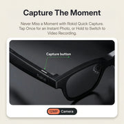Rokid AI Glasses (12MP POV Camera, Dual‑Eye AR Display, 89‑Language Translation) Rokid sunglasses with capture button and camera features on a beige background