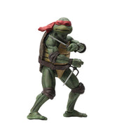 A Teenage Mutant Ninja Turtles action figure with a green and gray body, holding a sword and a staff, wearing a bandana and a belt.